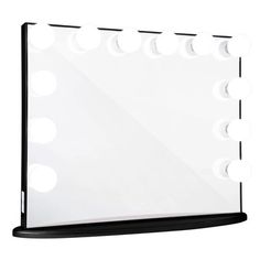 a large mirror with lights on it in front of a white wall and black stand