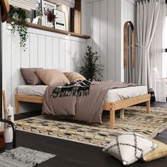 a bed sitting on top of a wooden floor next to a window