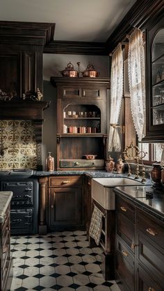 an old fashioned kitchen with black and white tile flooring