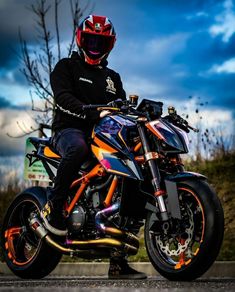 a man sitting on the back of a motorcycle with flames painted all over his body