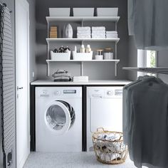 a washer and dryer sitting in a room next to each other with shelves on the wall