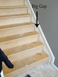 a baby sitting on top of a stair case