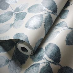 a blue and white floral wallpaper with silver foil on the bottom half of it