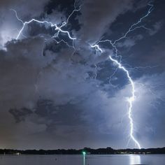 a lightning bolt is seen over a body of water