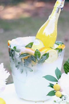 a bottle of lemonade sitting on top of a ice bucket