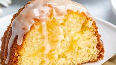 a close up of a cake on a plate with a fork and cup in the background