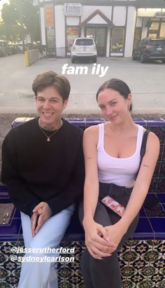 a man and woman sitting on a bench in front of a building with the words family above them