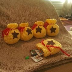 four crocheted stuffed animals sitting on top of a blanket