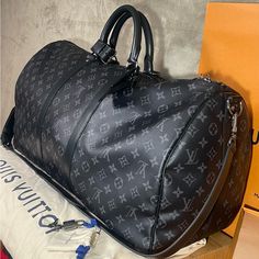 Purchased Directly From Louis Vuitton Store At Cherry Creek Mall In Denver Co Beautiful Duffle I’ve Used It 2/3 Times Never Got The Initials On The Tag So It’s Not Personalized Never Used The Lock Or Key So No Scratches Overall It’s An Amazing Duffle Will Send With Original Receipt And Original Packaging Men’s Louis Vuitton, Louis Vuitton Large Bag, Louis Vuitton Duffle Bag Men, Black Large Capacity Monogram Canvas Bag, High-end Black Monogram Canvas Bag, Black Signature Coated Canvas Travel Bag, Luxury Black Monogram Canvas Bags, Black Monogram Canvas Bag For Everyday Luxury, Black Monogram Canvas Luxury Bag