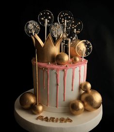 a birthday cake with gold and pink decorations