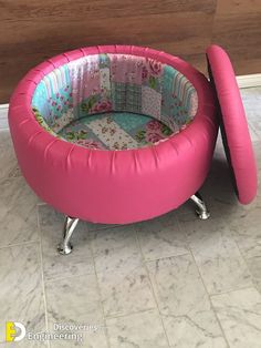 a pink baby bed sitting on top of a tiled floor