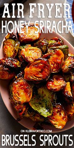 a plate full of brussel sprouts with the words air fryer honey sriraca