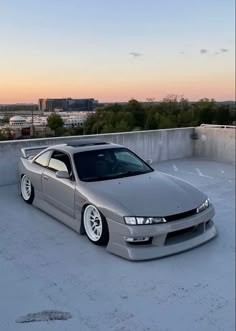 a silver car parked on top of a snow covered roof