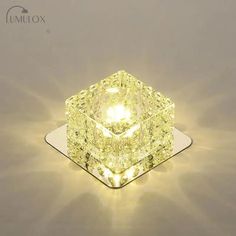 a yellow diamond sitting on top of a white surface with the light shining through it