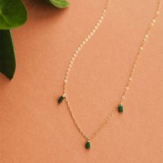 On a neutral background is a gold chain necklace with three rectangle emerald stones dangling from three different points on the chain. Trio Necklace, Adornment Jewelry, Green Stones, Gold Chain Necklace, Green Stone, Special Someone, The Chain, Gold Chain, Dark Green