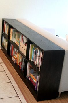 a bookshelf that is next to a couch