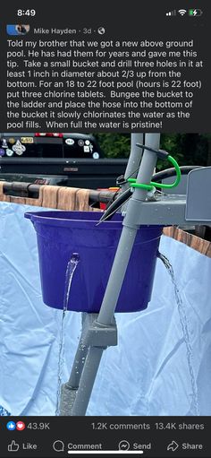 a blue bucket filled with water sitting on top of a table