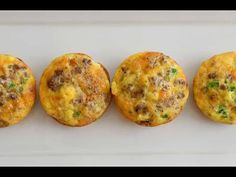 three muffins are lined up on a white plate