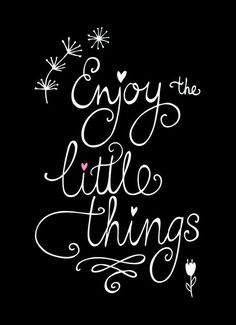 the words enjoy the little things written in cursive writing on a black background