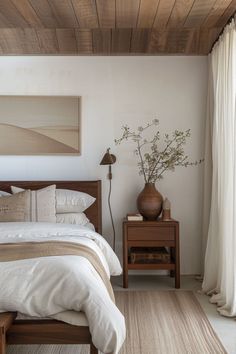 a bedroom with a bed, nightstand and painting on the wall