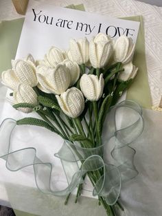 a bouquet of white flowers sitting on top of a table next to a card that says you are my love