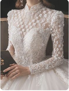 a woman in a wedding dress holding a book