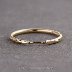 a close up view of a gold wedding ring on a gray surface with the words,