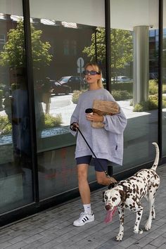 a woman walking her dog on a leash