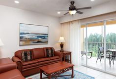 a living room filled with furniture and a sliding glass door that leads to a balcony