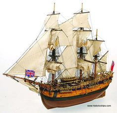 an old fashioned sailing ship with white sails