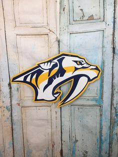 the nashville predators logo is hanging on an old door