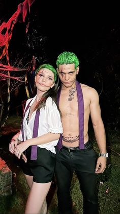 a man and woman with green hair standing next to each other