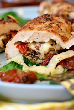 a close up of a plate of food with meat and cheese