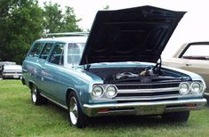 an old station wagon with its hood open