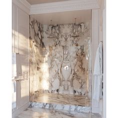 a bathroom with marble walls and flooring