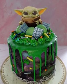 a star wars themed cake with a baby yoda sitting on top of the cake