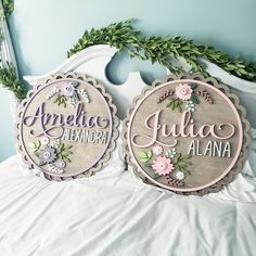 two personalized wooden signs sitting on top of a bed