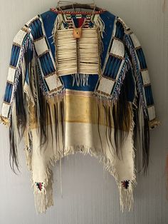 an old native american jacket hanging on a wall