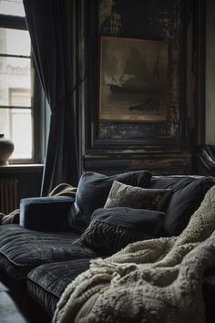 a living room filled with furniture and a painting on the wall