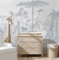 a baby's room with a giraffe wallpaper and wooden dressers