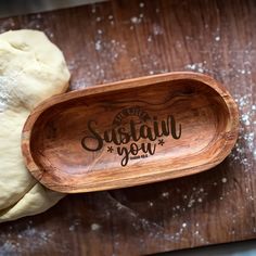 a wooden spoon with the words suttah you on it next to some dough