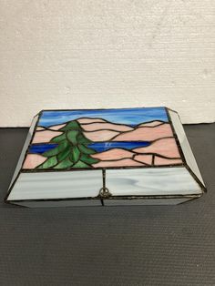 a stained glass box sitting on top of a table