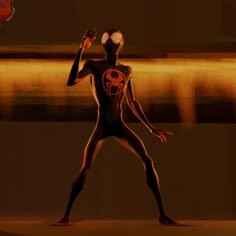 a man in a body suit holding a soccer ball with both hands and wearing a spiderman mask