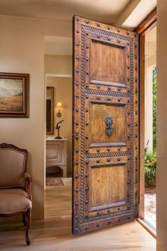 an open wooden door in the middle of a living room