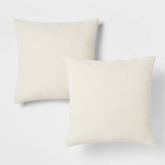 two white pillows sitting next to each other