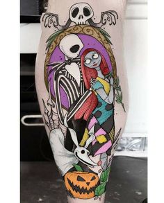 a person with a tattoo on their leg that has a skeleton and skeletons in it