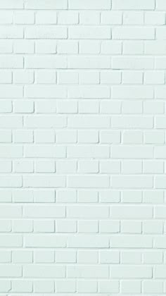 a white brick wall that is painted green