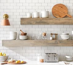 the kitchen is clean and ready to be used for cooking or baking, with white subway tiles on the wall