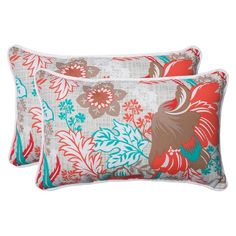 two red and blue floral pillows on a white background, one with an orange flower design