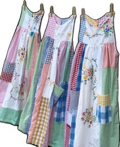 three dresses are hanging on a clothes line with different colors and patterns, one is multicolored